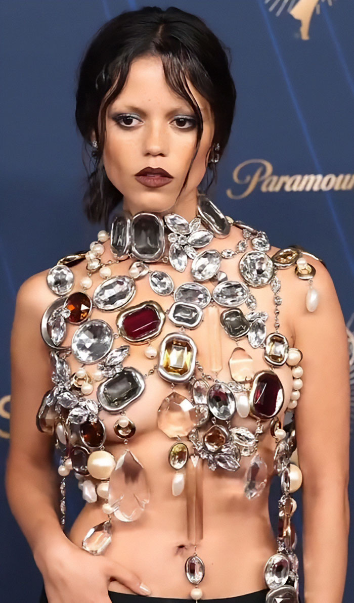 Jenna Ortega posing in a risky diamond-encrusted outfit with bold makeup at the 2025 Emmys event. Jenna Ortega posing in a risky diamond-encrusted outfit with bold makeup at the 2025 Emmys event.
