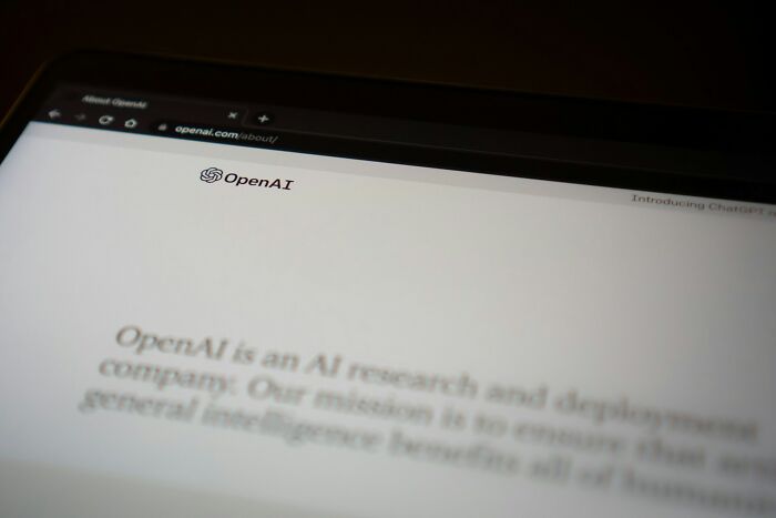 OpenAI website displayed on a laptop screen, focusing on AI research and development content.