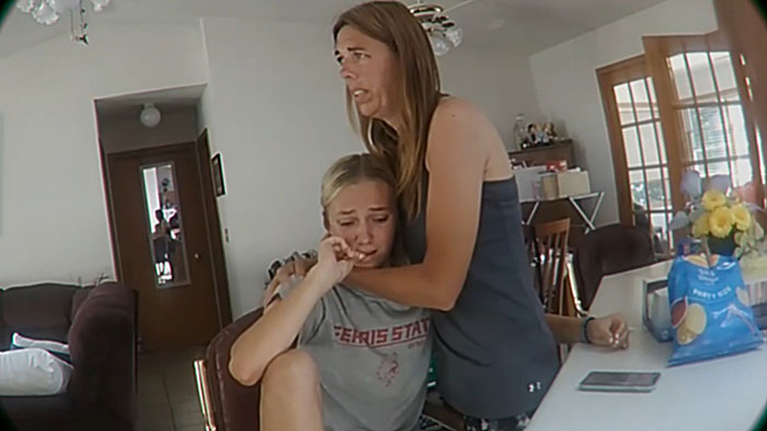 Woman comforting crying daughter in a kitchen setting as prosecutor discusses mom secretly tormenting daughter over time