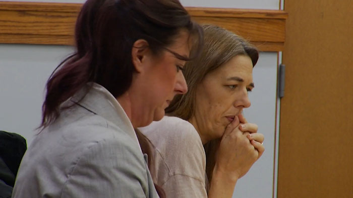 Two women in a courtroom setting, one appearing concerned as prosecutor explains mom secretly tormented daughter over a year.