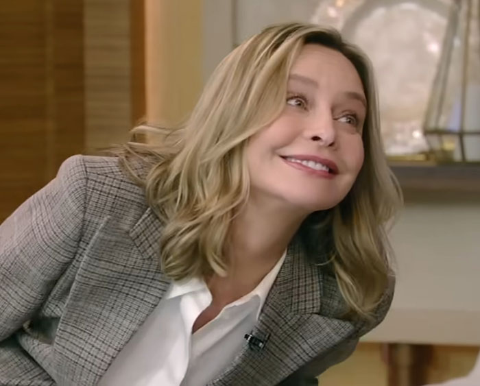 Woman with blonde hair smiling and leaning forward during an interview about people who knew celebrities before fame.