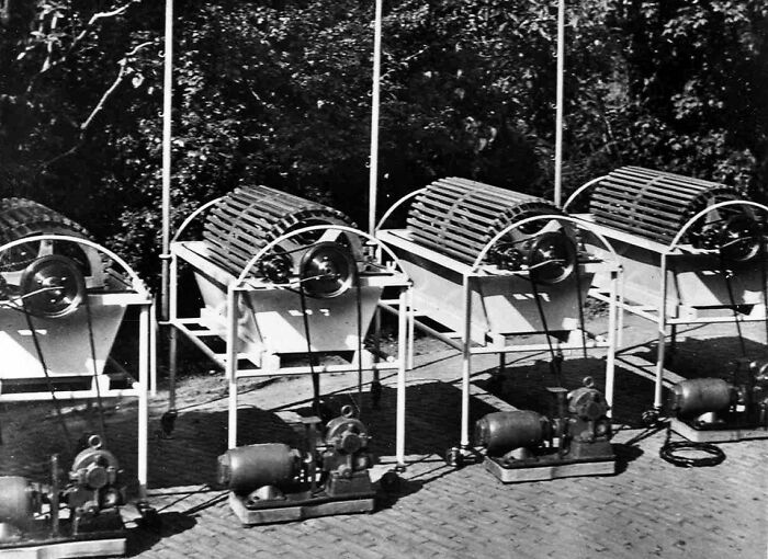 Old-school medical equipment with multiple mechanical devices lined up outdoors, showing vintage medical technology.