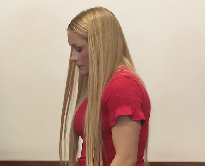 Young woman with long blonde hair wearing a red dress, related to autopsy findings of newborn found in cheerleader's closet.