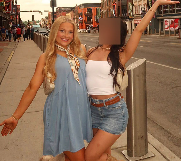 Two young women posing on a city street, one in a blue dress, related to autopsy findings and newborn gender news.