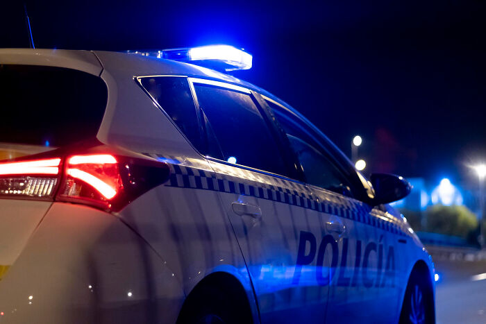 Police car with flashing lights at night, illustrating lawyers and cops revealing dumbest ways people incriminated themselves.