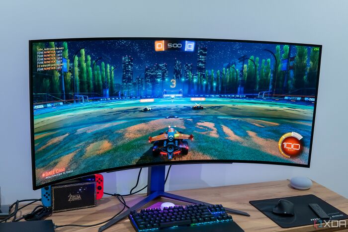 Curved widescreen monitor displaying a Rocket League match, illustrating the next big thing that totally flopped in gaming setups.