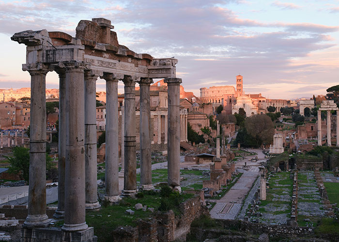 Ancient Roman ruins with tall stone columns at sunset, illustrating interesting scientific facts with a slightly eerie atmosphere.