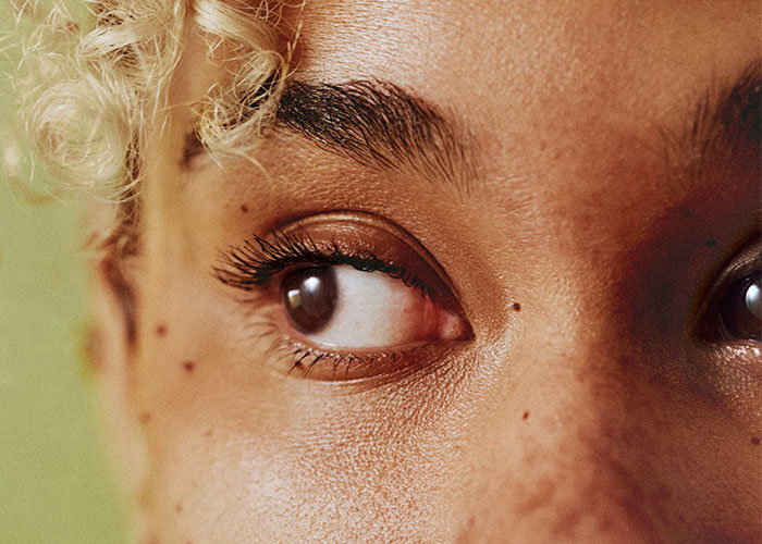 Close-up of a person's eyes and skin showing detailed textures, illustrating interesting scientific facts with an eerie vibe.
