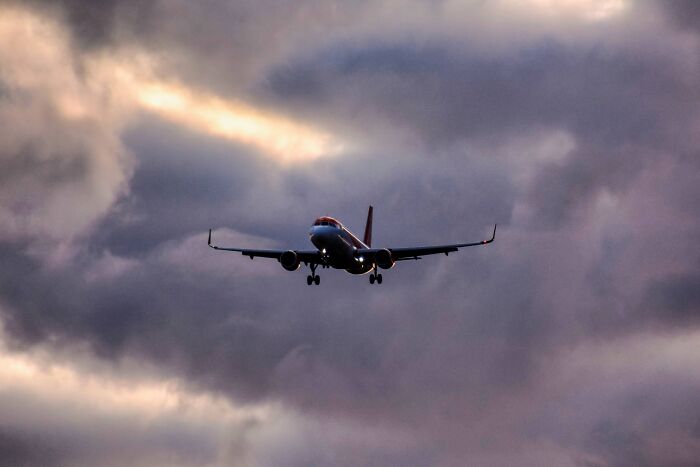 Airplane flying through dark, stormy clouds, capturing a very lucky moment in a terrifying situation.