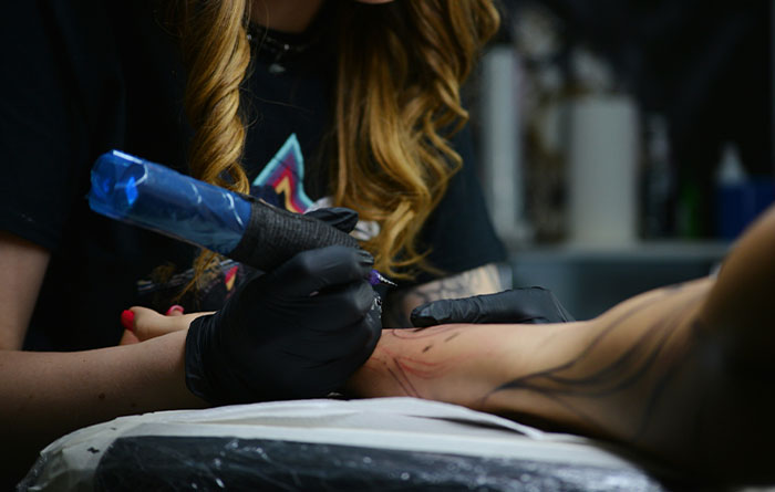 Woman Lies About Tattoo Idea To Petty Friend, Watches Her Get It Permanently Inked