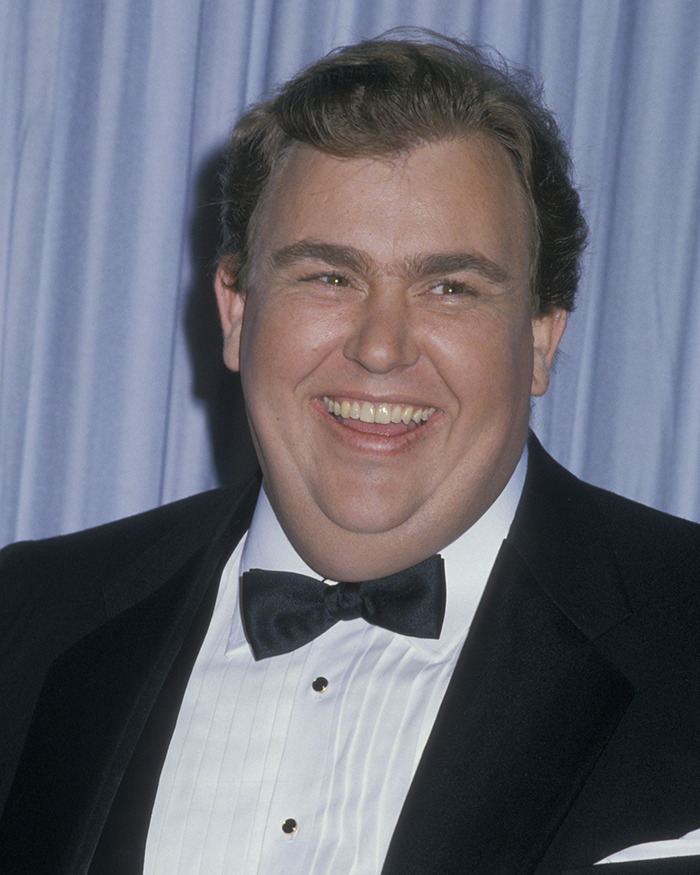 John Candy smiling in a tuxedo at an event, illustrating Macaulay Culkin's story about his father. John Candy smiling in a tuxedo at an event, illustrating Macaulay Culkin's story about his father.