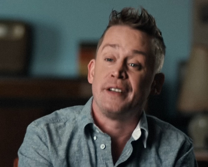 Macaulay Culkin speaking in an interview setting, sharing insights about John Candy and his father’s behavior. Macaulay Culkin speaking in an interview setting, sharing insights about John Candy and his father’s behavior.