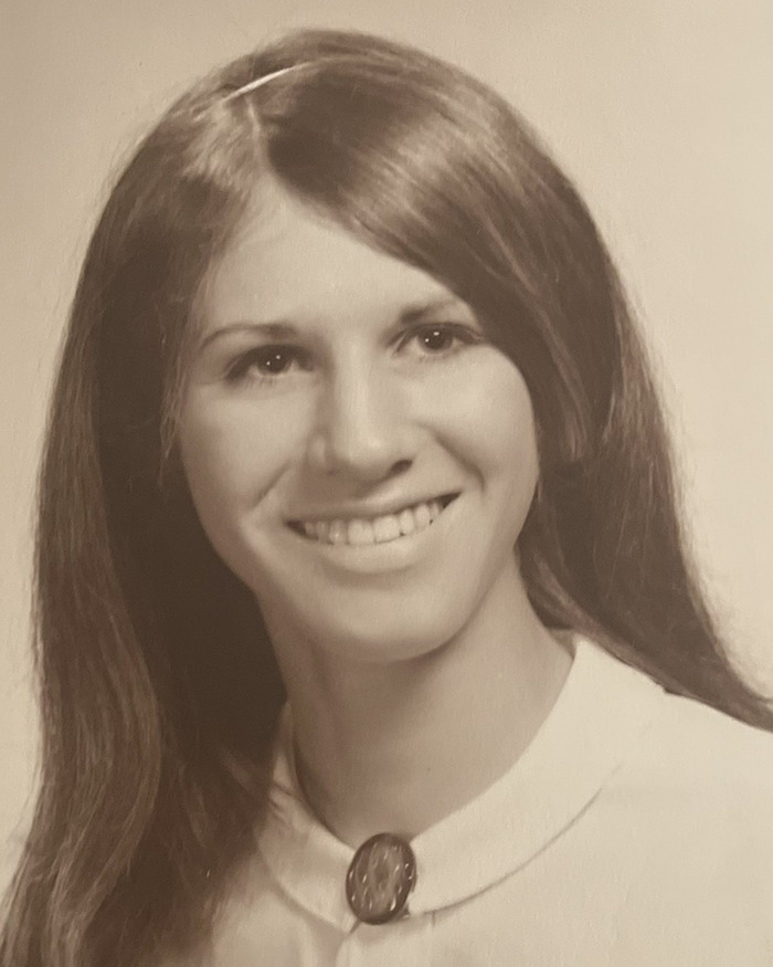 Black and white portrait of a smiling young woman, related to a brutal cold case solved by police after 52 years.