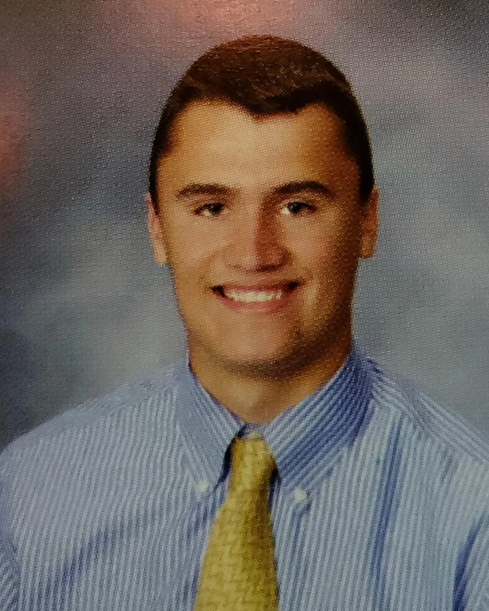 Young man in a striped shirt and yellow tie, related to story about Charlie Kirk bullying claims in high school.