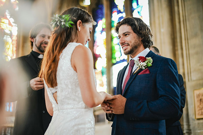 Bride and groom exchanging vows in a church setting, illustrating a robotically calculated choice for brains over heart.