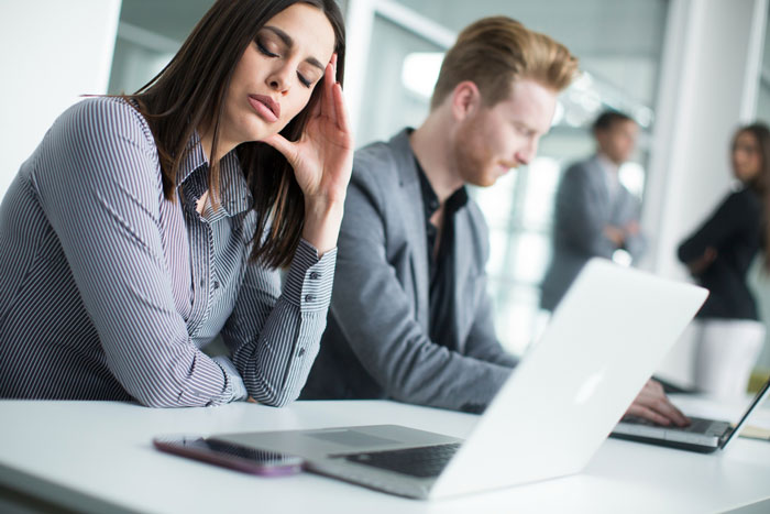 Stressed employees sitting at desks in office, showing frustration with manager’s overly strict dress code policy. Stressed employees sitting at desks in office, showing frustration with manager’s overly strict dress code policy.