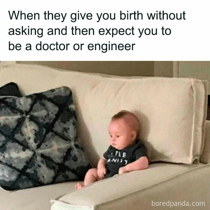 Baby sitting on a couch looking unamused, illustrating the struggle and humor of working in medicine expectations.