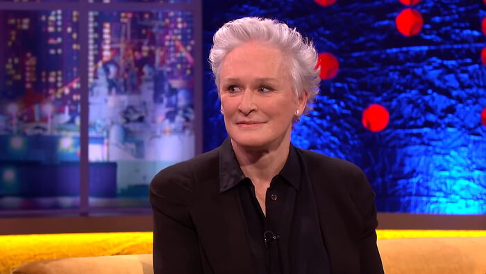 Glenn Close smiling during a talk show interview, sharing heartwarming celebrity encounters with netizens.