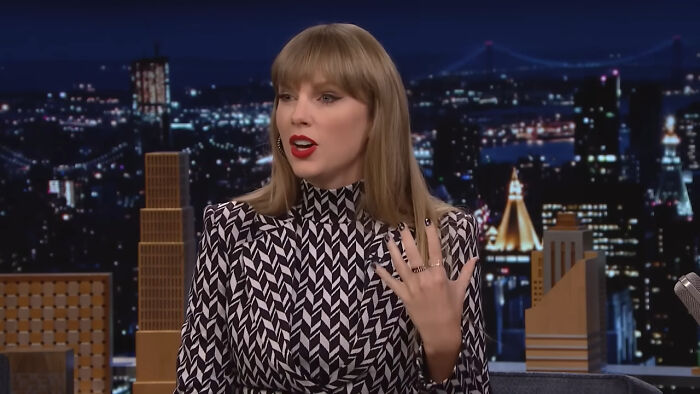 Taylor Swift speaking on a late-night show, sharing a heartwarming celebrity encounter that still makes fans smile today.