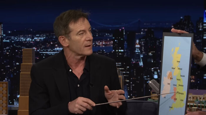 Actor explaining a map during a late-night talk show, capturing a heartwarming celebrity encounter moment.