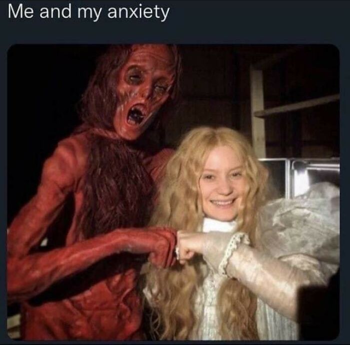 Woman smiling and fist bumping a scary monster figure, representing anxiety in funny and weirdly comforting mental health memes.