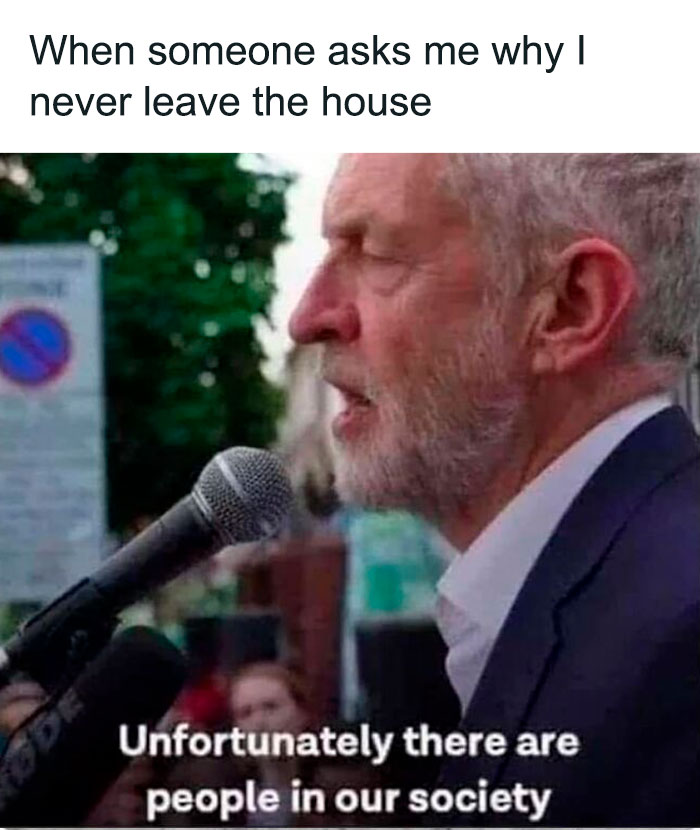 Older man speaking into a microphone with funny mental health meme text about social anxiety and not leaving the house.