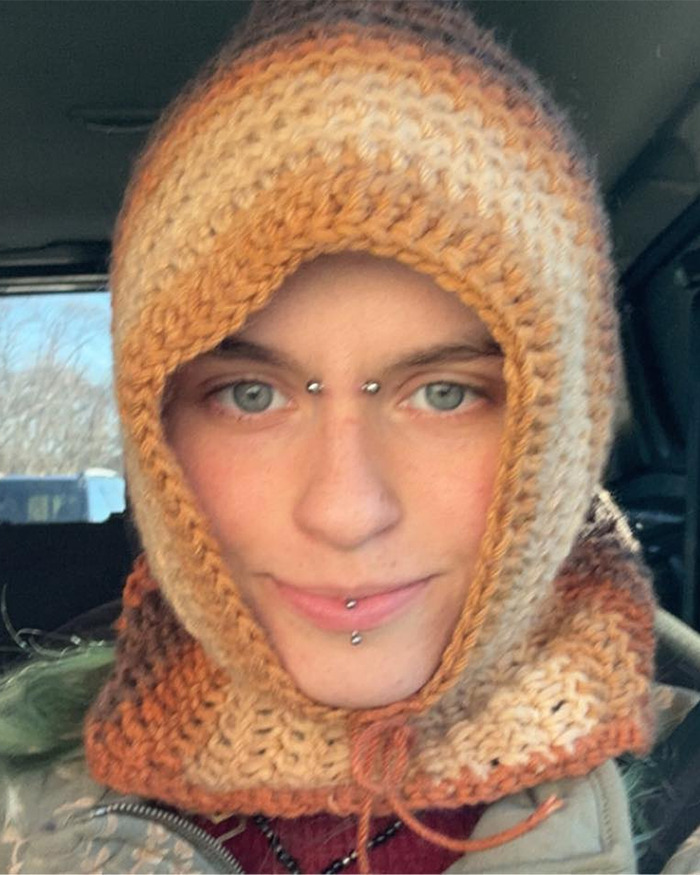 Close-up of Minneapolis suspect's furry girlfriend wearing a knitted hood with facial piercings inside a vehicle.