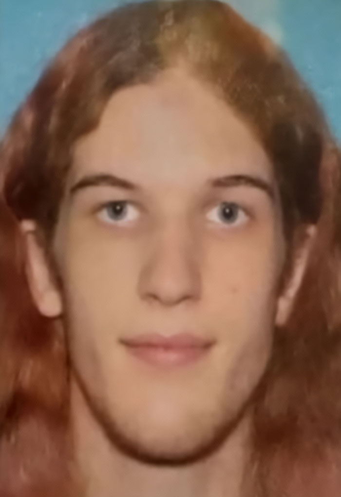 Close-up photo of Minneapolis suspect with long hair, related to furry girlfriend and disturbing journal entries about their relationship.