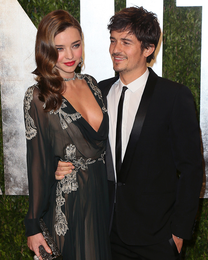 Miranda Kerr and Orlando Bloom posing together at a formal event, discussing breakup with Katy Perry.