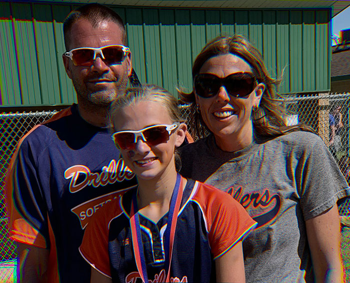 Family wearing sports jerseys and sunglasses, illustrating psychological expert insights on anonymous online bullying of teen daughter. Family wearing sports jerseys and sunglasses, illustrating psychological expert insights on anonymous online bullying of teen daughter.