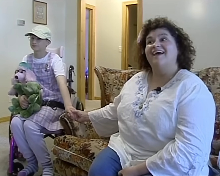 Mother and teen daughter sitting in living room, illustrating psychological expert discussion on online bullying effects. Mother and teen daughter sitting in living room, illustrating psychological expert discussion on online bullying effects.