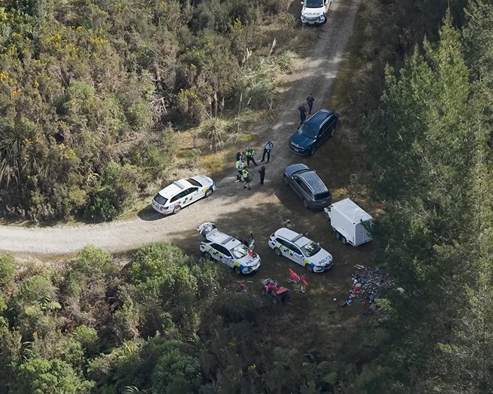 Police vehicles and officers at a rural scene during the search related to mom of 3 missing kids and fugitive dad shootout.