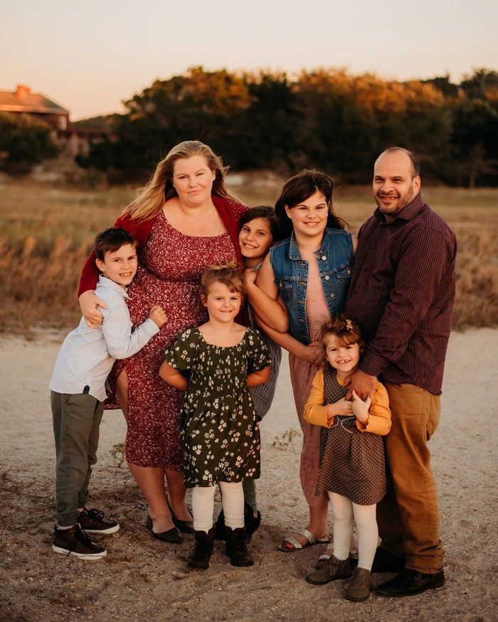 Family portrait of a mom of five with her husband and children outdoors during golden hour in a natural setting. Family portrait of a mom of five with her husband and children outdoors during golden hour in a natural setting.