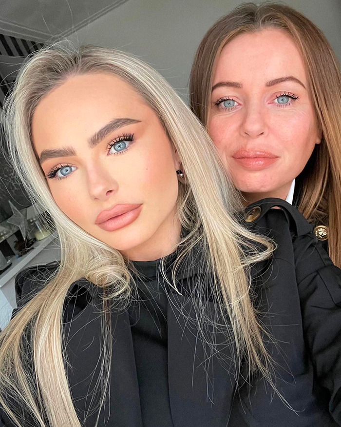 Two women with blue eyes and light makeup, one with blonde hair and the other with brown hair, posing indoors. Two women with blue eyes and light makeup, one with blonde hair and the other with brown hair, posing indoors.
