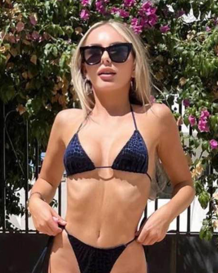 Woman in black bikini and sunglasses outdoors with flowers in background, related to mom of student jailed for life in Dubai Woman in black bikini and sunglasses outdoors with flowers in background, related to mom of student jailed for life in Dubai