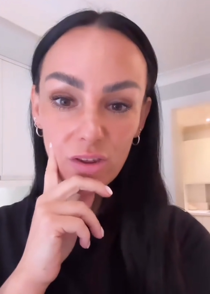 Woman with dark hair and hoop earrings expressing concern while talking about mom pulling son from school over snack ban.