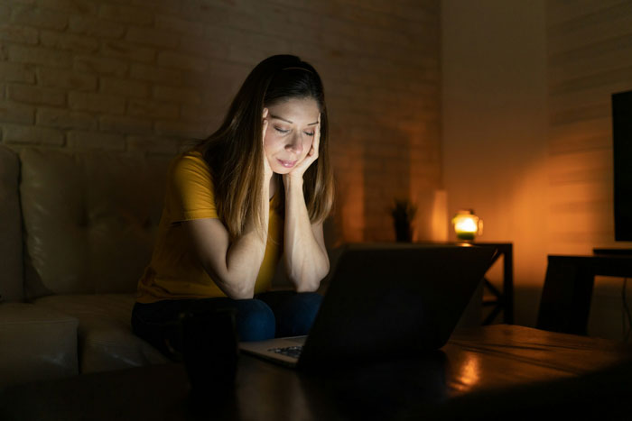 Woman learning the truth about why she never got to study abroad, looking thoughtful while using a laptop at home. Woman learning the truth about why she never got to study abroad, looking thoughtful while using a laptop at home.