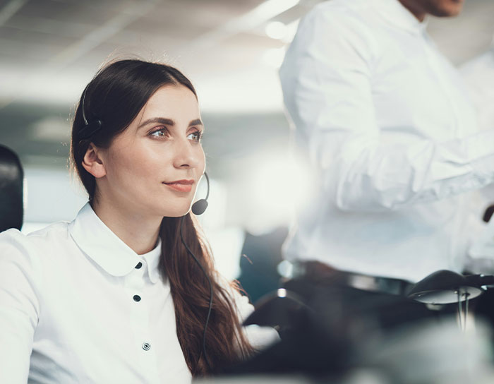 Customer service professional with headset, focused on work in a modern office environment, highlighting hated professions.