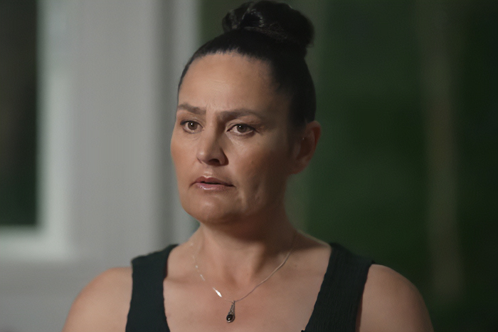 Mom of kids who vanished into wilderness speaking during an interview, wearing a black tank top and necklace.