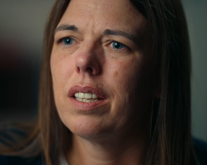 Close-up of a woman expressing remorse, related to a mom making a shocking confession about anonymously bullying daughter.