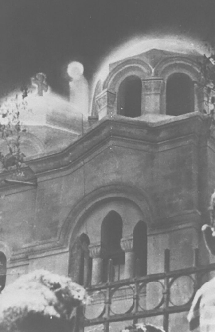 Old building with glowing mysterious figure appearing above, a photo that seems normal until you learn the mysteries behind it.