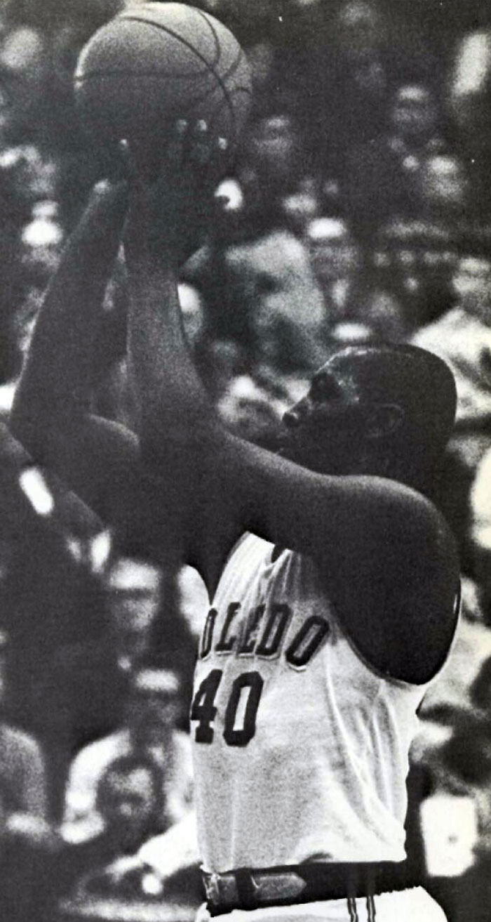 Black and white photo of a basketball player from Toledo shooting during a game, linked to celebrities who vanished without a trace.