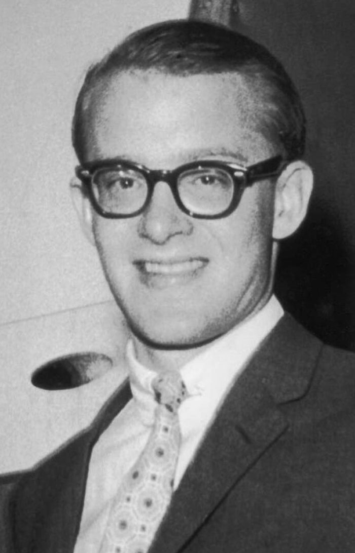 Black and white photo of a man in a suit and glasses linked to celebrity vanished without a trace conspiracy theories.