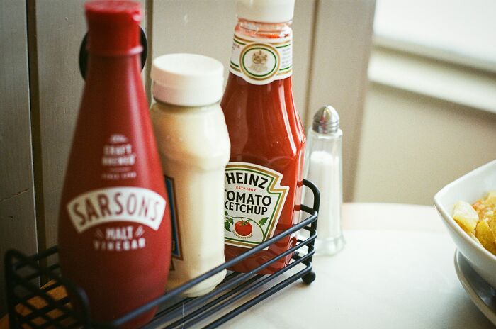 Condiment bottles arranged in a restaurant setting highlighting common health violations found during inspections.