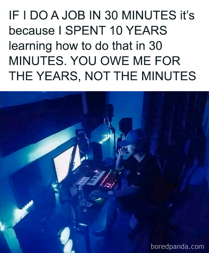 Man working late in a dimly lit room with computer and music equipment highlighting parts of working in 2025 that are a nightmare.