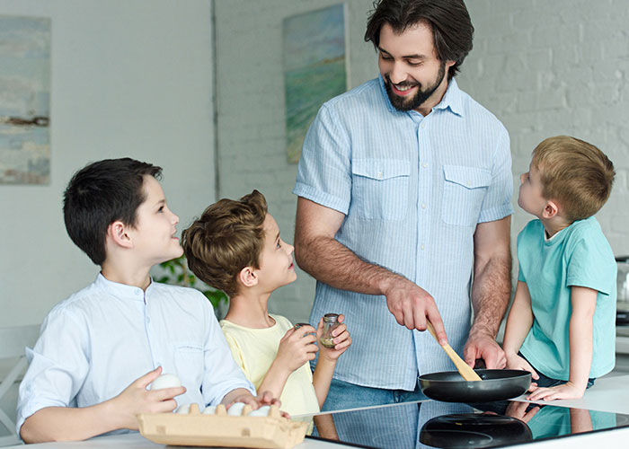 Young man raising his younger siblings in the kitchen, reflecting the challenges parents made son raise 7 younger siblings.