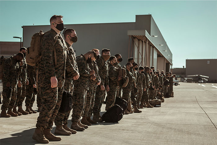 Group of soldiers standing in formation outside a building, representing strength and resilience in getting even with a bully.