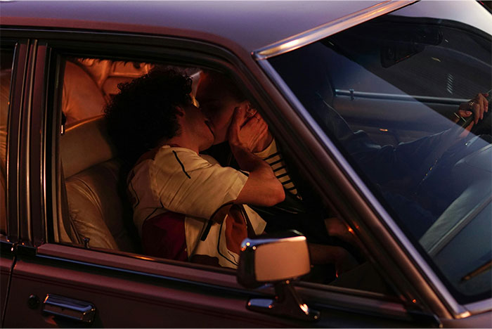 Two people sharing a romantic moment inside a car, capturing the glorious moment of getting even with a bully.