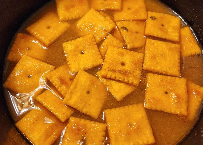 Cheddar crackers soaked in a flavorful sauce demonstrating a simple life hacks recipe that actually works in the kitchen.
