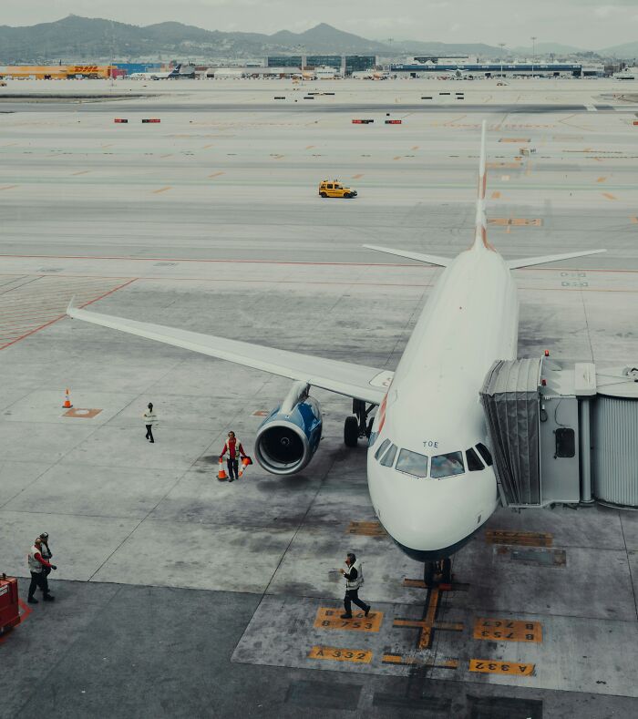 Airplane at the gate with airport staff on the tarmac, symbolizing surprising moments and iconic teacher comments.